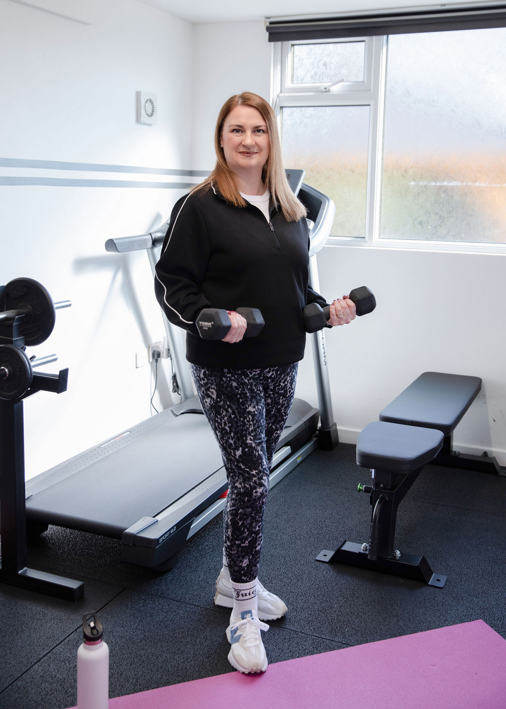 Suzy Newson with dumbbells in the private women's gym