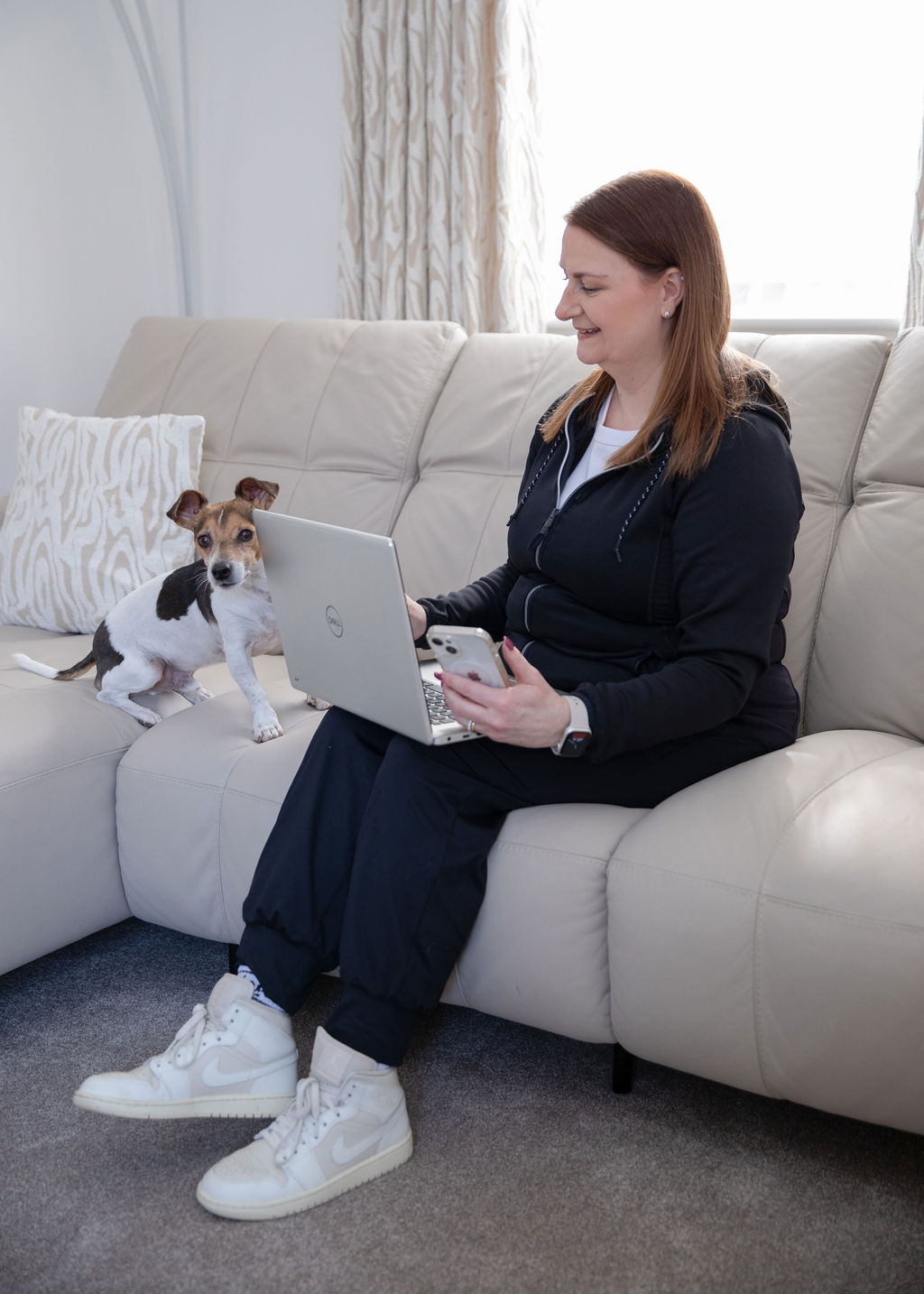 Suzy Newson planning client fitness programmes at home with her dog